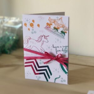Unicorn Fairground multicolour stamped background card - with Stampin' Up melon mambo ribbon