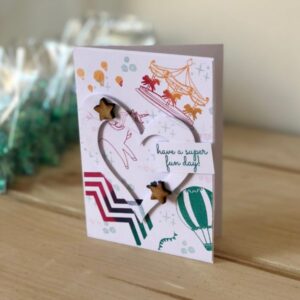 Unicorn Fairground multicolour stamped background card - die cut heart and stars