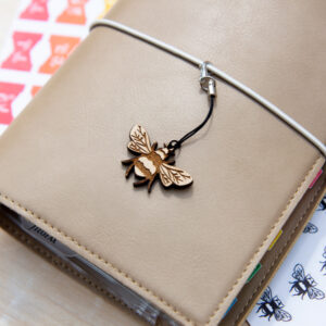 Bee Planner Charm attached to the front of a filofax planner