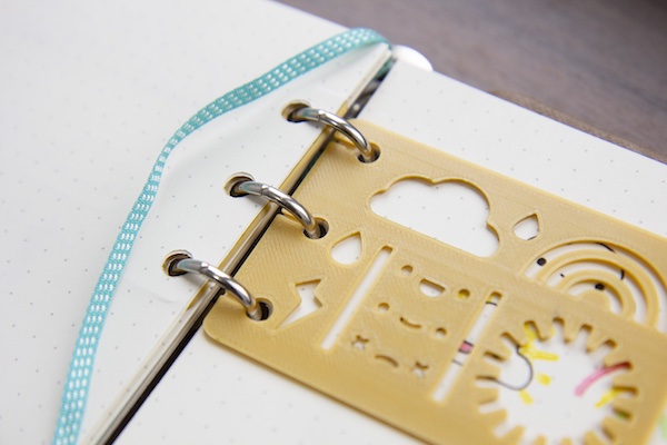 clip-in mini planner stencil attached to planner rings