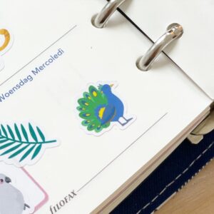 Peacock sticker placed on a planner page