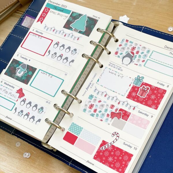 filofax planner page spread featuring cute penguins christmas planner stickers