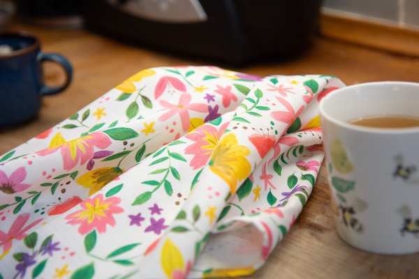 floral tea towel folded on the kitchen counter