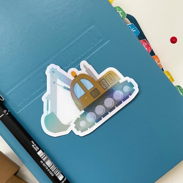 Large digger sticker on the front of a bullet journal