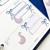 Swans and bows planner stickers on a planner page