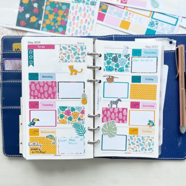 open filofax planner page covered with bright jungle themed tropical stickers