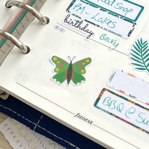 Green butterfly sticker on planner page