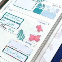 Pink butterfly stickers on a planner page