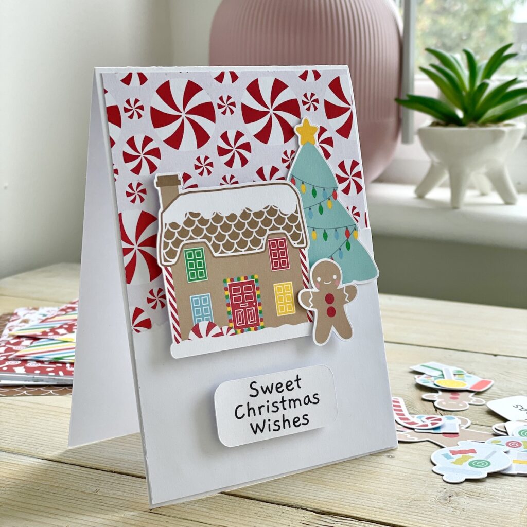 Cute gingerbread house handmade with candy swirl background. Handmade Christmas card by StickerKitten UK