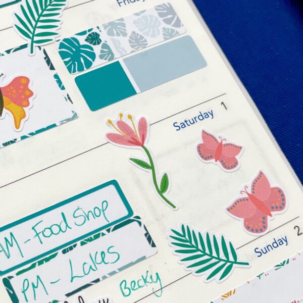 Pink flower sticker on a planner page