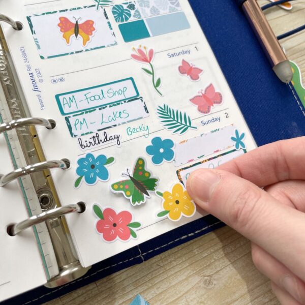 Colourful flower stickers on a planner page