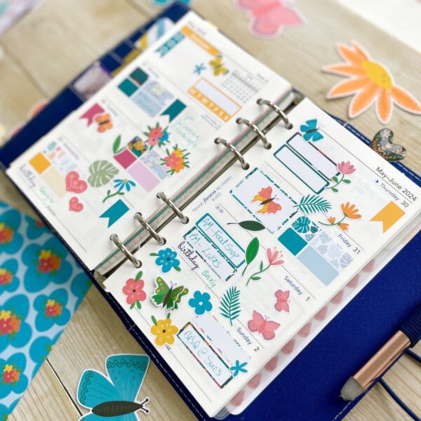 Open Filofax planner with lots of colourful flower and butterfly stickers