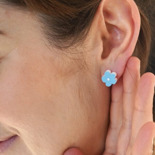 Pretty blue flower earrings worn by Sarah