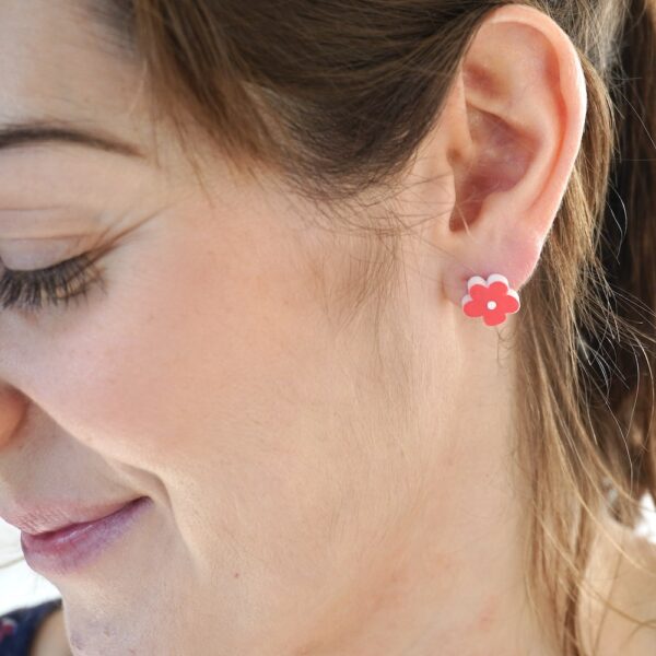 Pretty red flower earrings worn by Sarah