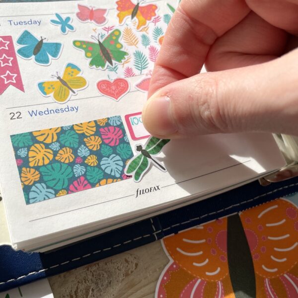 Dragonfly sticker on a planner page