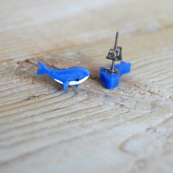 Cute blue whale stud earrings close up